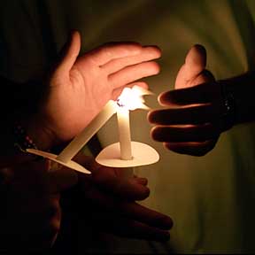 Closeup photo of students' hands and candles