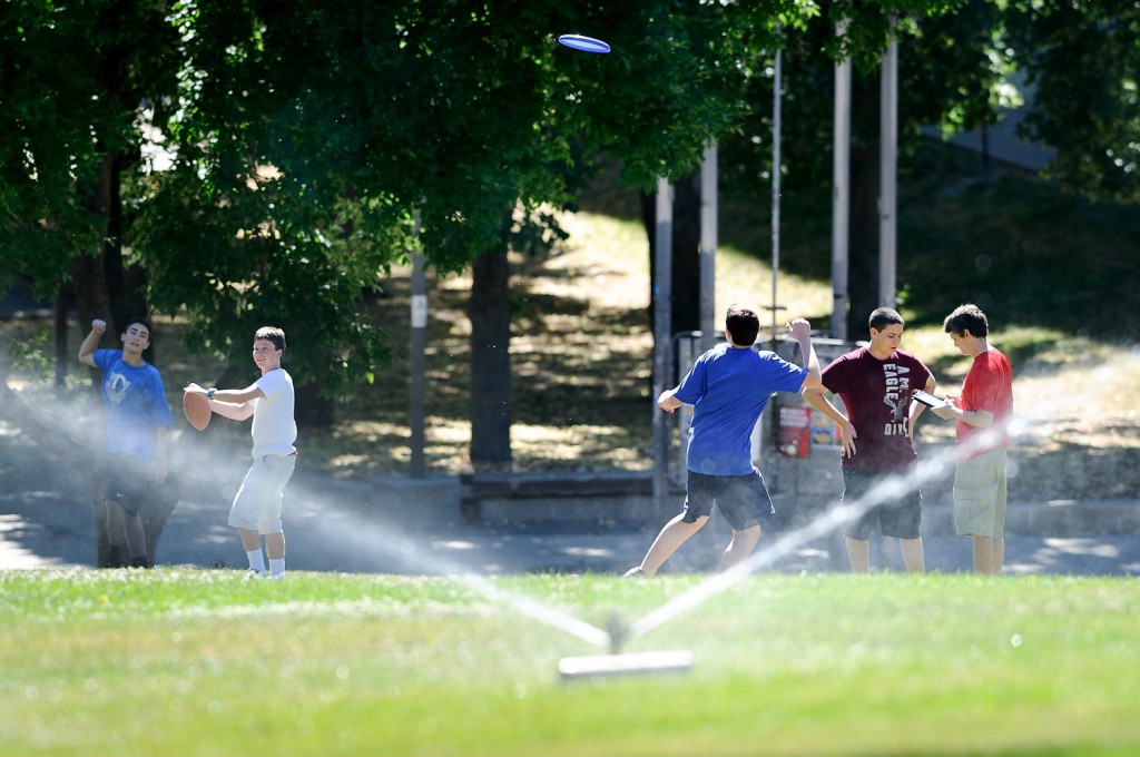 As a sprinkler waters the grass on Bascom Hill, high school students attending a sports journalism workshop hosted by UW-Madison throw a football and a Frisbee before they tackle their first writing assignment – a how-to column on throwing spirals and achieving distance.