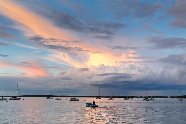 Sailboats bob in Lake Mendota near the Memorial Union Terrace just after a brief thunderstorm and just as the sun sets.
