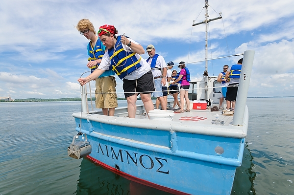 Demonstrating why Lake Mendota is known for hands-on research, Nazan Gillie (right), instructional program manager in the UW’s zoology department, collects samples from the lake floor during an Aquatic Invertebrate Field course.