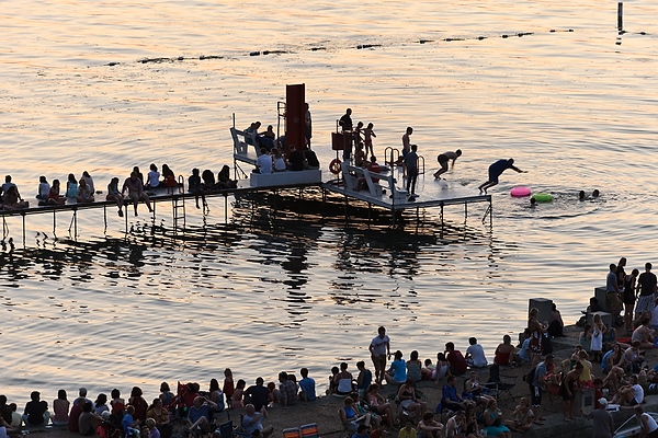 The Memorial Union Terrace and its swimming pier — one of the campus’s most popular spots — attract a crowd as daylight wanes and people await the annual Rhythm and Booms fireworks show held each summer across the lake at Warner Park.