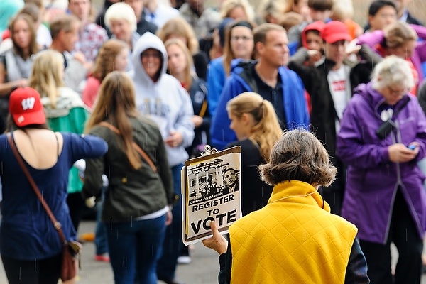 Volunteers -- clipboards in hand -- walked along the crowd on Observatory Drive, urging people to register to vote as they waited for the event to start.