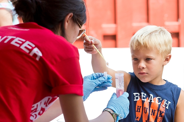 A fruitful experience: A youngster extracts DNA from strawberries at a science booth.