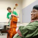 Photo: Students playing bass, Richard Davis listening