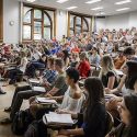 Assistant professor Keith Woodward speaks with students on the first day of class in his Geography 101 course in Science Hall.