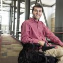 Jeff Mahlum, a graduate student who completed a certificate program as a student health care advocate in the Center for Patient Partnerships (CPP) at the Law School, is pictured in the atrium of the Law Building at the University of Wisconsin-Madison on Sept. 16, 2014. Mahlum learned firsthand how confusing and daunting the health care system can be following a 2011 diving accident that left him paralyzed from the chest down. Mahlum, who now uses a motorized wheelchair, has recently begun medical school at UW-Madison.