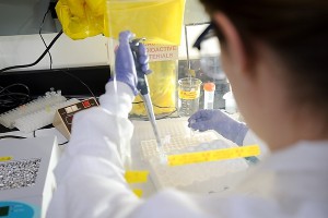 Studying the process by which RNA protein is made from DNA, a doctoral student works with radioactive tracers in a lab at the Biochemical Sciences Building in April 2012.