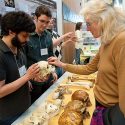 Anthropology graduate students Marc Kissle (far left) and Aaron Sams (left) point out the distinguishing characteristics of a group of skulls to Claire Vanderslice (right) during Darwin Day inside the Microbial Sciences Building at the University of Wisconsin-Madison on Feb. 7, 2009.