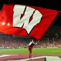 A member of the UW Spirit Squad hoists a motion W flag into the air following a UW touchdown during the Wisconsin vs UNLV football game at Camp Randall Stadium on Sept. 1, 2011. Wisconsin went on to win the game, 51-17. (Photo by Bryce Richter / UW-Madison)