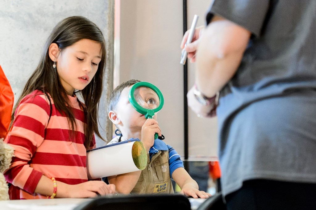 Eyeing a “What Makes Light Different” information booth, a youngster visits an event at the Discovery Building during the Wisconsin Science Festival, a statewide celebration of curiosity and exploration.