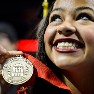 Dana Duncan shows off her Chancellor's Scholar medal. The program offers merit-based scholarships to gifted students from underrepresented minority groups and disadvantaged backgrounds. Duncan earned a bachelor's degree in communication sciences and disorders.