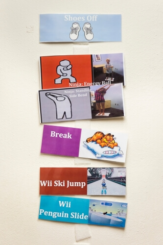 Visual cards depict the order of movements that children practice as they participate in the balance study.