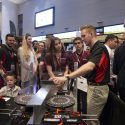 UW-Madison mechanical engineering senior Sidney Smith demonstrates the BadgerLoop Halbach wheels at the team’s exhibit booth during the second day of SpaceX’s Hyperloop Pod Competition Design Weekend. The powerful magnetic wheels spin along both sides of the Hyperloop track’s center rail, stabilizing the levitating transport pod and propelling it down the Hyperloop track. 