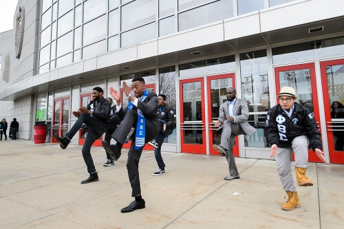 A graduate performs a step routine with his Phi Beta Sigma fraternity brothers following UW–Madison's 2015 winter commencement ceremony.