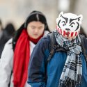 A student keeps warm in her Badger hat as she walks along Linden Drive at the University of Wisconsin-Madison during a class change on Jan. 26, 2016. (Photo by Bryce Richter / UW-Madison)