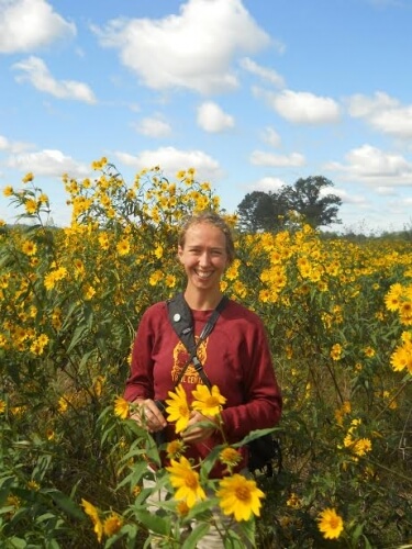 Amy Alstad stands in a bunch of Sawtooth Sunflowers that she describes as glorious.