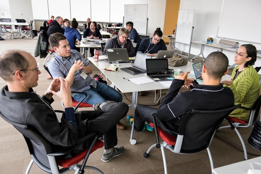 A group of Wisconsin middle school science teachers work in teams as they collaborate with UW–Madison staff and experienced computer game designers during a workshop held at the Wisconsin Institute for Discovery.