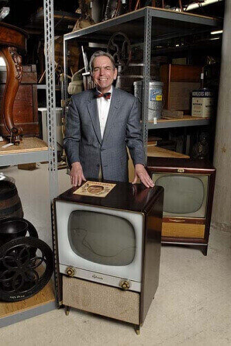 Baughman poses in 2007 with 1950s vintage television sets. He was an expert in Journalism history in 20th century and the beginnings of TV in America.