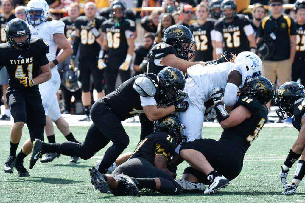 Members of the UW-Oshkosh Titans football team, shown in action against Finlandia University last September, will be testing WeightUp monitors to count reps and test for proper form in their weightlifting routines.