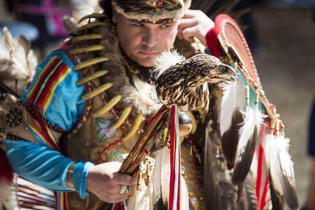 Head Dancer Joe Syrette, a member of the Ojibiwe tribe from Batchewana, Ontario, holds an eagle head staff during a Spring Powwow held on campus in 2014.