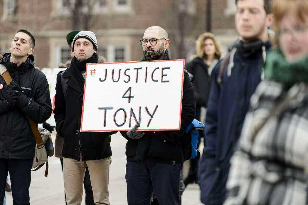 A marcher displays the hashtag used to promote the observance on social media.