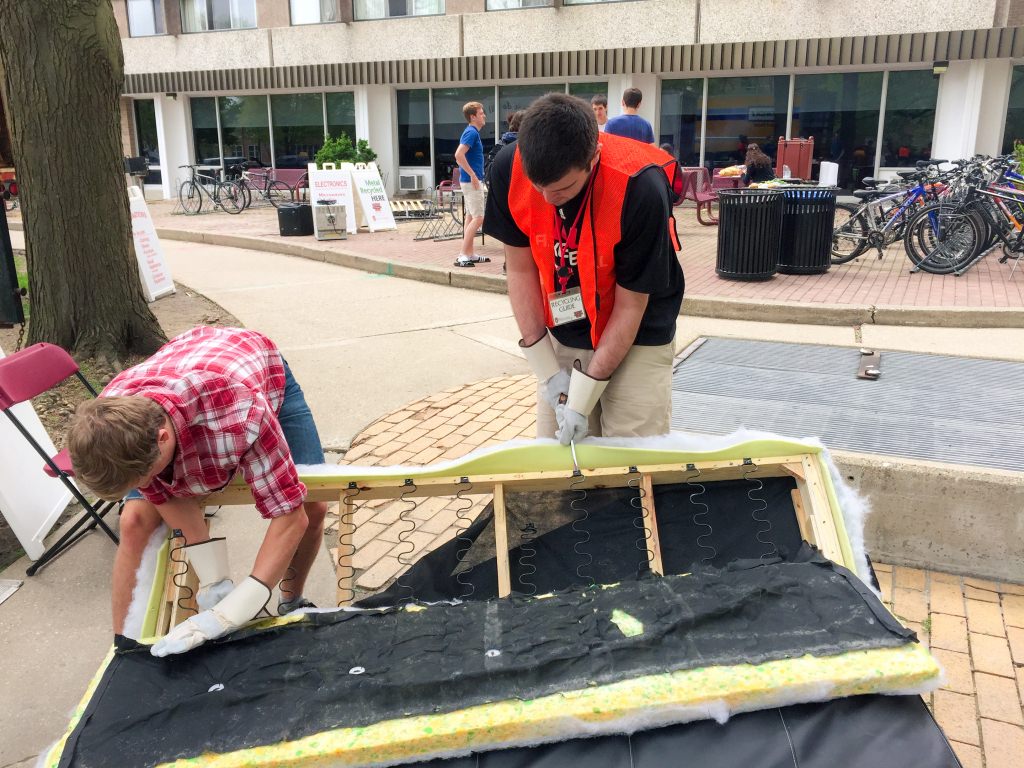 Volunteers salvage usable material from a discarded futon during last year's University Residence Halls move-out.