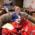 Photo: Student with laptop wearing earbuds