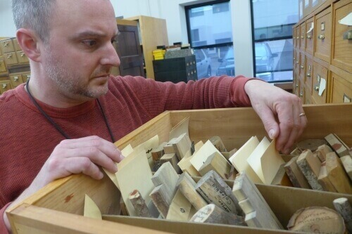 Alex Wiedenhoeft inspects samples in the world's largest research wood collection at the U.S. Forest Products Lab, with samples from about 20,000 species of woody plants.