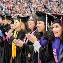 Graduates celebrate as they sing Varsity.