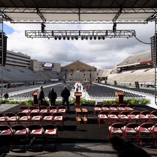 Staff make final preparations for the Camp Randall ceremony Saturday morning.