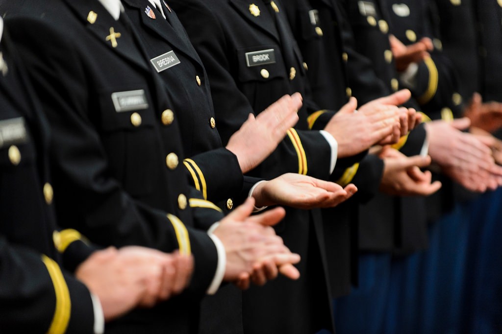 Photo: Closeup of uniformed people clapping