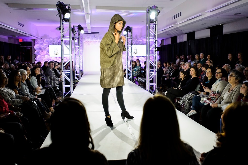 Model Zashary Torres walks the runway showcasing a cozy coat.