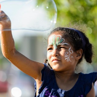 Photo: At a table sponsored by the group Adult Role Models in Science, Hallie Justice, 6, waves a large soap bubble wand.