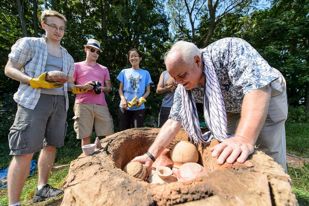 Photo: Kenoyer putting pottery into kiln