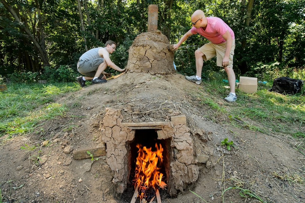 Photo: Students sealing cap of burning kiln