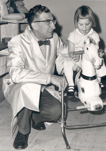 Photo: Harry Waisman with girl on rocking horse