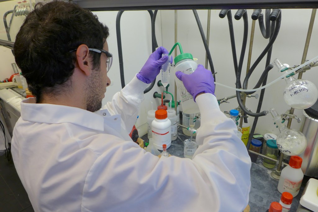 Photo: Alex Amatuni, a UW–Madison intern, performs a chemical synthesis at Arrowhead