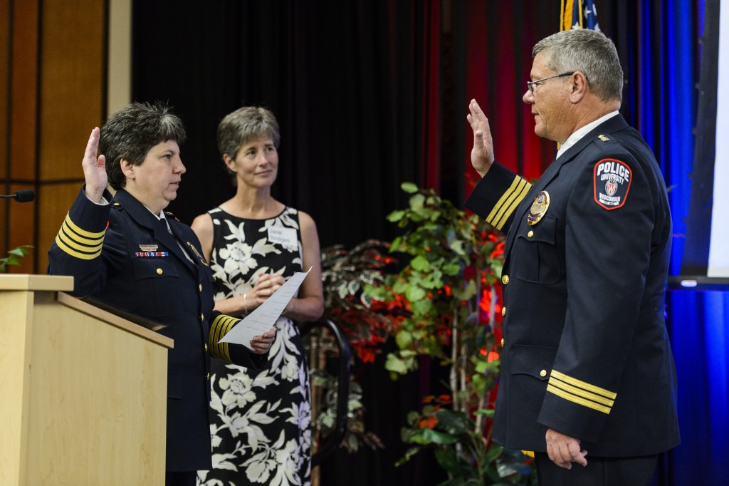 Riseling leads Assistant Chief Brian Bridges in the oath of office as Bridges accepts the role of interim chief.