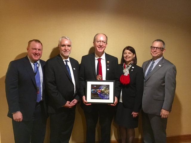 U.S. Rep. Bill Foster, center, receives The Science Coalition's Champion of Science award Monday at the International Conference on High Energy Physics in Chicago. Also pictured are, from left, Ben Miller, UW–Madison director of federal relations; Tim Killeen, president of the University of Illinois; Lisa Freeman, Northern Illinois University executive vice president and provost; and Bruce Layton, Northwestern University special assistant to the president for government relations.