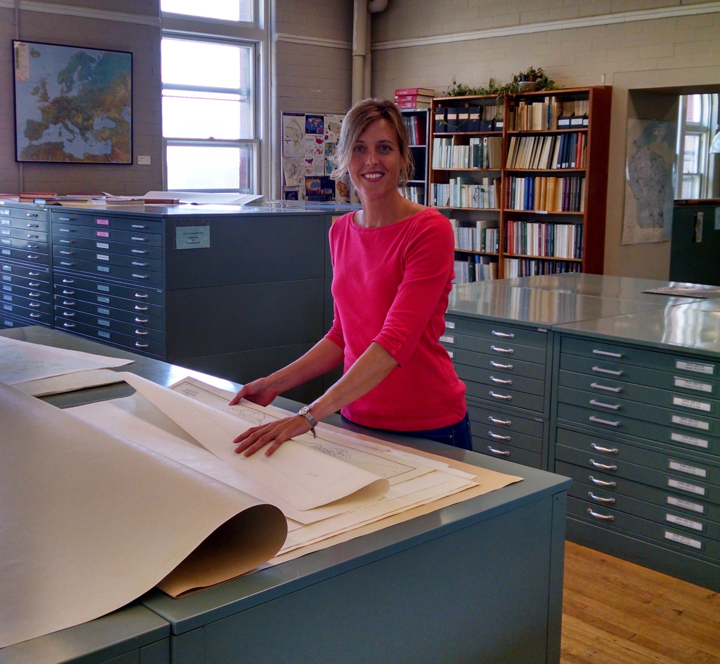 Jaime Stoltenberg, map and geospatial data librarian in the Department of Geography, is picutured in the Arthur H. Robinson Map Library in Science Hall at the UW–Madison.