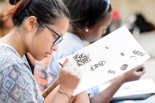 Photo: Penny Xiong practicing on a piece of paper