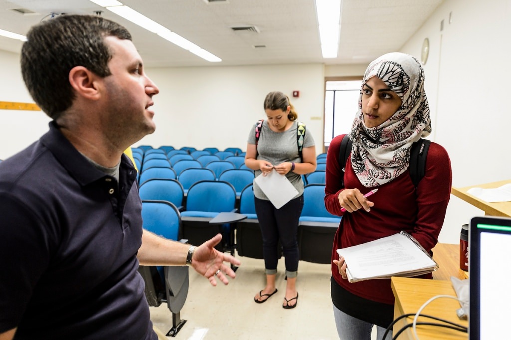 Michael Titelbaum, associate professor of philosophy, answers questions from undergraduate student Jinan Aljaziri, right, an international student from Saudi Arabia, following a Philosophy 211 class.