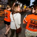 SAFEwalk staff members escort a UW-Madison student. SAFEwalk is a free campus service that provides trained, two-person walking escorts throughout the main campus.