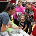 In Bayfield, Emma Wiermaa, outreach specialist for the UW-Stevens Point Northern Aquaculture Demonstration Facility, explains fish cultivation to Hartlynn Gary (center) and Connor Defoe, as Anastasia Gordon (pink shirt) and Jeanette Hoopman look on.