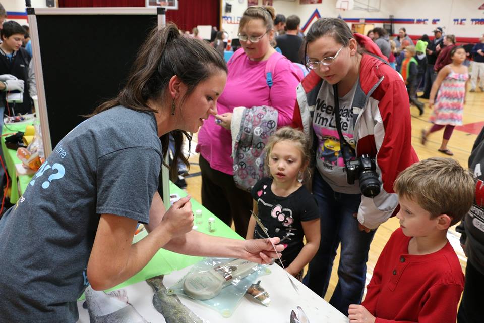 In Bayfield, Emma Wiermaa, outreach specialist for the UW-Stevens Point Northern Aquaculture Demonstration Facility, explains fish cultivation to Hartlynn Gary (center) and Connor Defoe, as Anastasia Gordon (pink shirt) and Jeanette Hoopman look on.