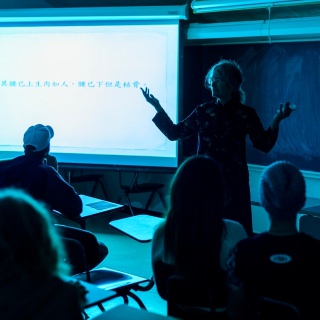 Rania Huntington, professor of Asian languages and cultures, tells a traditional Chinese ghost story during a Chinese-style haunted house at the Mosse Humanities Building Friday. The benefit event, hosted by the UW-Madison Chinese Language and Culture Club, also featured theatrical characters and clues for guests to solve a murder mystery.