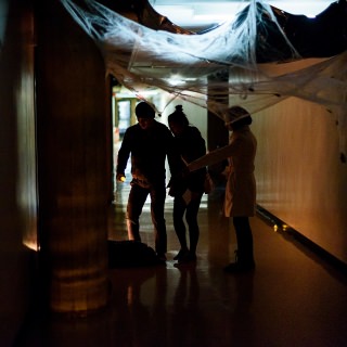 Participants navigate a dark hallway.