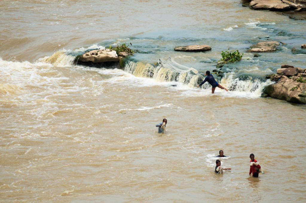 Photo: Fishermen casting nets in river