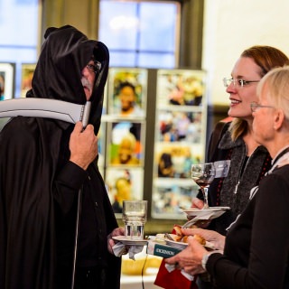 Dressed as the Grim Reaper, Don Miner, a friend of the Odyssey Project, mingles with guests at Night of the Living Humanities Thursday at the University Club.