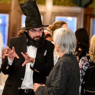 Dressed as President Abraham Lincoln, Kevin Mullen, assistant director of Odyssey, speaks with guest Cindy Poe.